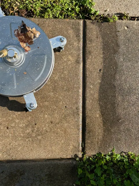 Morford’s surface cleaner lifting buildup from a concrete walkway