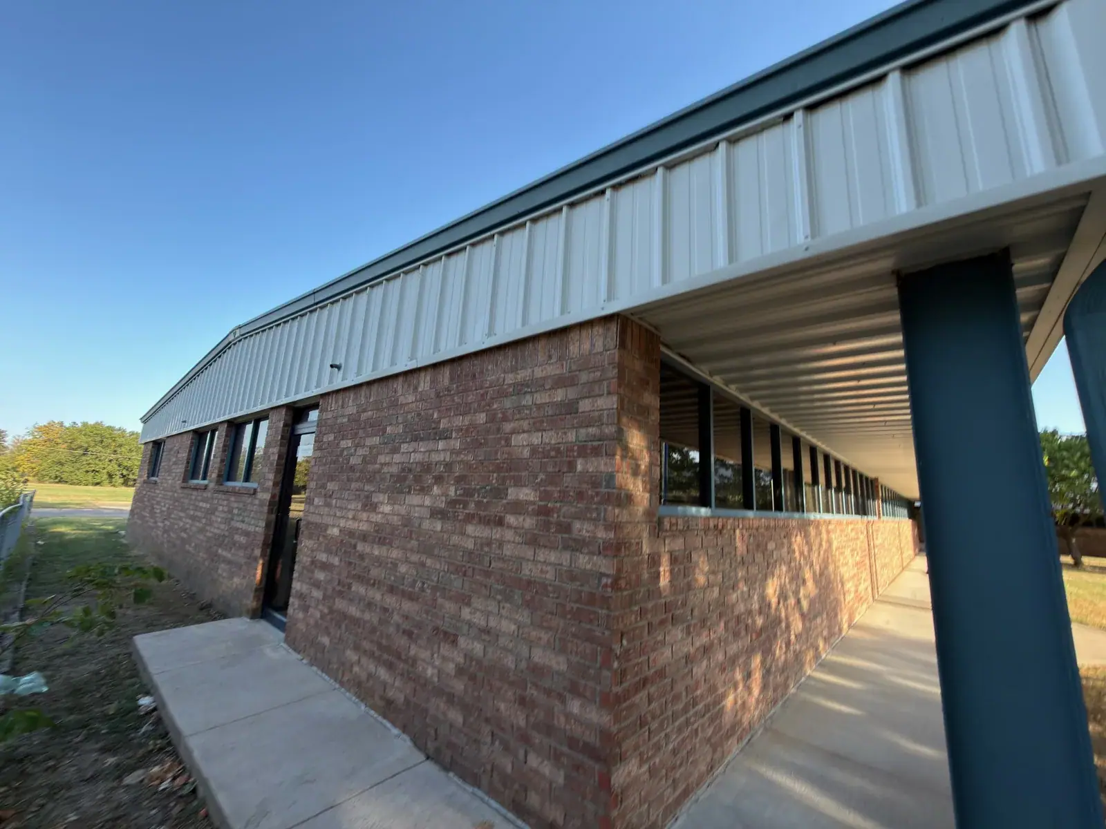 The completed brick exterior and blue columns at the same commercial cleaning job